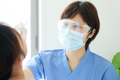 nurse taking temperature in japan